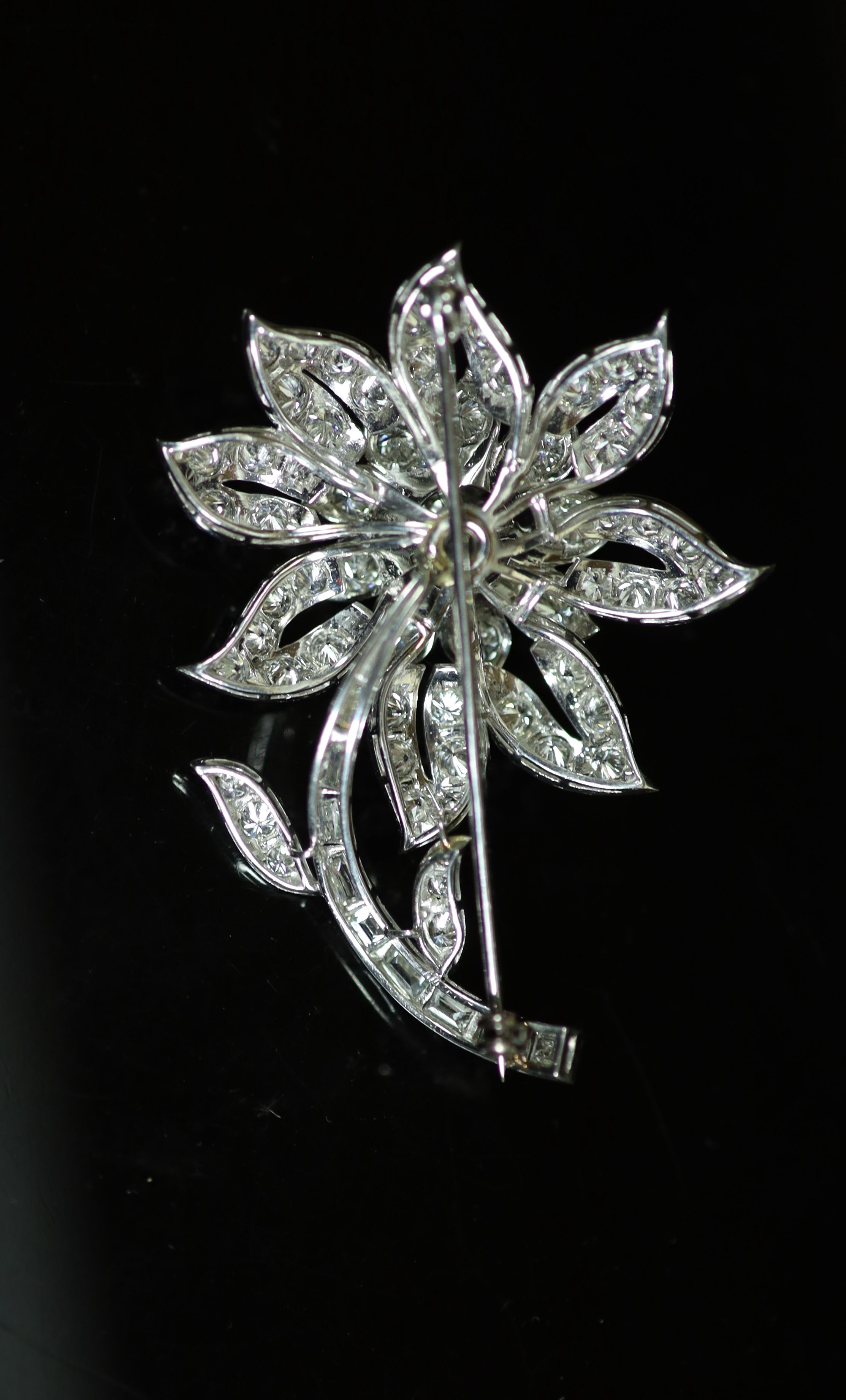 A white gold and diamond encrusted flower brooch